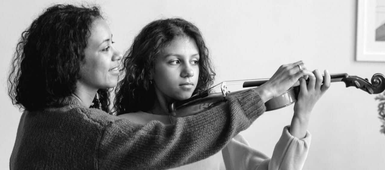 Parent and child practicing violin together