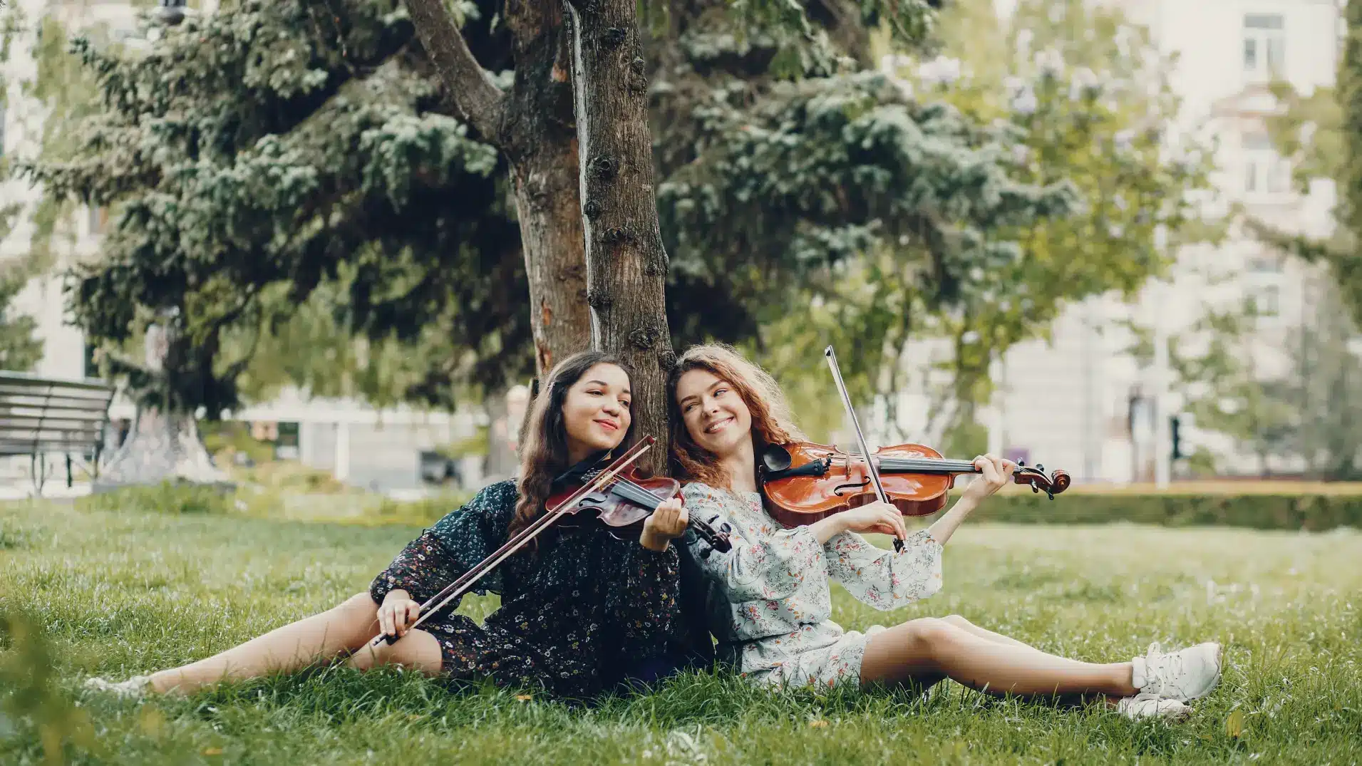 Violin students playing together outdoors, sharing music and inspiration